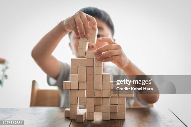 boy playing with logic puzzle - teaser stock-fotos und bilder