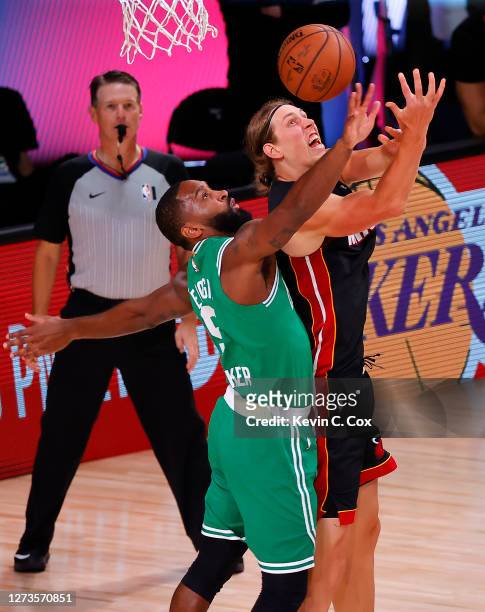 Kelly Olynyk of the Miami Heat draws a foul from Brad Wanamaker of the Boston Celtics during the fourth quarter in Game Three of the Eastern...
