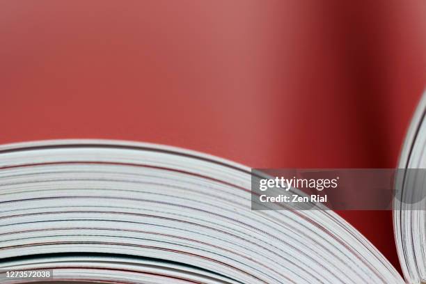 close up of a book open to a blank red page - school close up stock-fotos und bilder