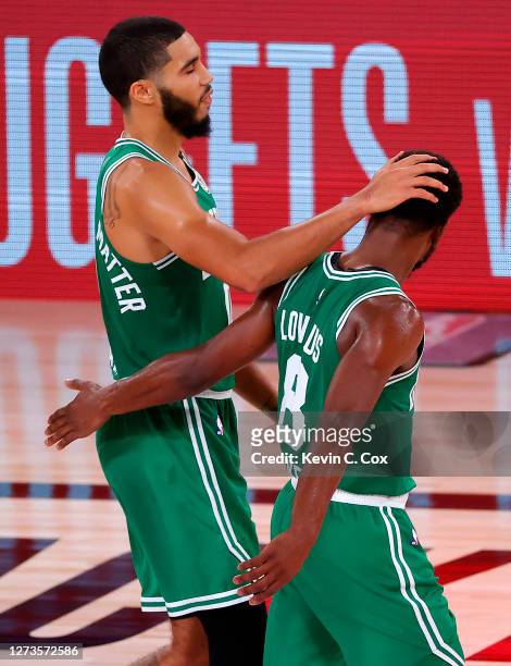 Jayson Tatum of the Boston Celtics and Kemba Walker of the Boston Celtics react after their win over Miami Heat in Game Three of the Eastern...