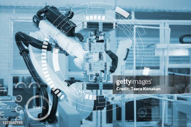 automatic robot mechanical arm is working in the modern automobile parts factory. - medical technology stock-fotos und bilder