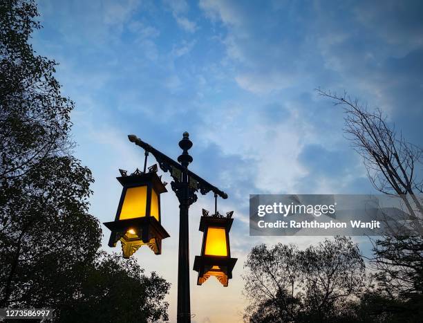 traditional thai lamp on pole near road in old town area. - lamp shade fotografías e imágenes de stock