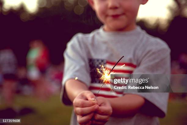 little boy holding sparkler - fourth of july stock pictures, royalty-free photos & images