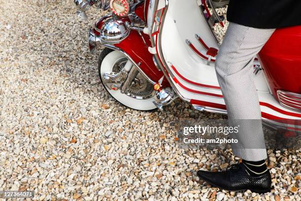 man sitting on scooter - mod stockfoto's en -beelden