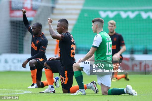 Alfredo Morelos of Rangers takes the knee in support of the Black Lives Matter Movement prior to the Scottish Premiership match between Hibernian and...