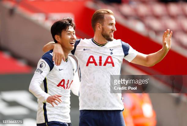 Heung-Min Son of Tottenham Hotspur celebrates with teammate Harry Kane after scoring his team's third goal during the Premier League match between...