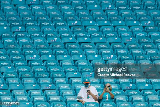 Miami Dolphins fans look on from the stands prior to the game between the Miami Dolphins and the Buffalo Bills at Hard Rock Stadium on September 20,...