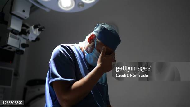 worried healthcare male nurse at operating room in hospital - tired healthcare worker stock pictures, royalty-free photos & images