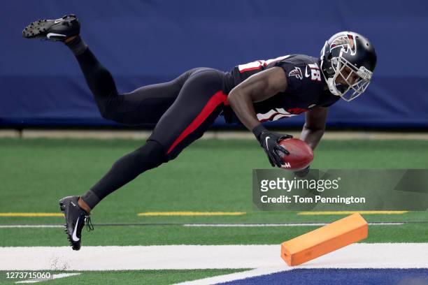 Calvin Ridley of the Atlanta Falcons dives across the goal line to score a touchdown against the the Dallas Cowboys in the first quarter at AT&T...