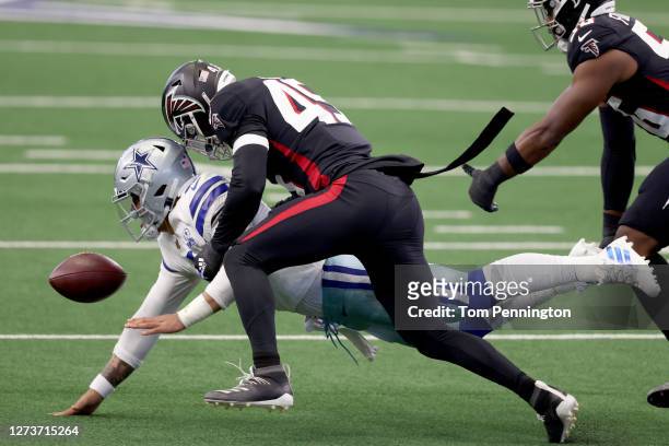 Dak Prescott of the Dallas Cowboys fumbles the ball after being hit by Deion Jones of the Atlanta Falcons and Dante Fowler Jr. #56 of the Atlanta...