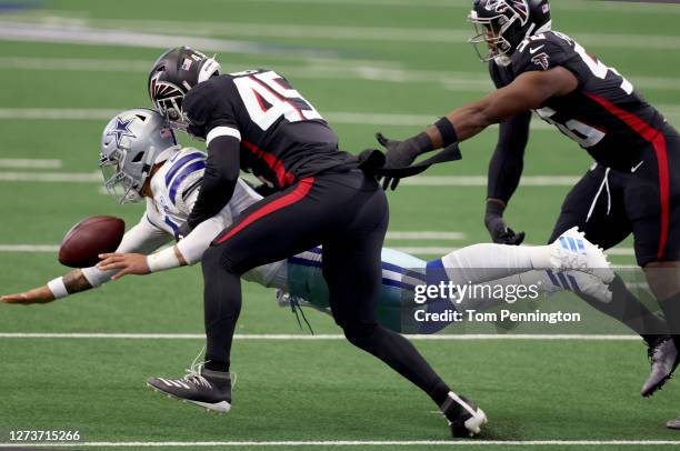 Dak Prescott of the Dallas Cowboys fumbles the ball after being hit by Deion Jones of the Atlanta Falcons and Dante Fowler Jr. #56 of the Atlanta...