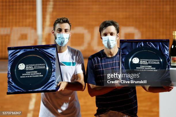 Marcel Granollers of Spain and playing partner Horacio Zeballos of Argentina pose with their trophies after winning the men's doubles final against...