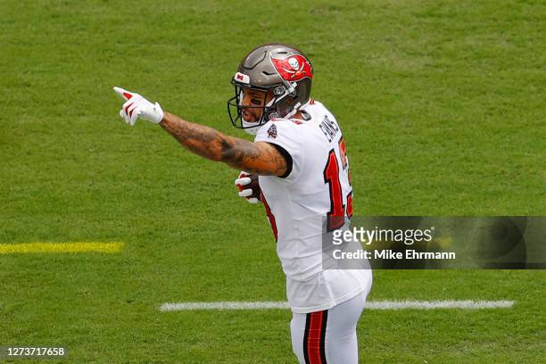 Mike Evans of the Tampa Bay Buccaneers celebrates scoring a touchdown during the first quarter against the Carolina Panthers at Raymond James Stadium...