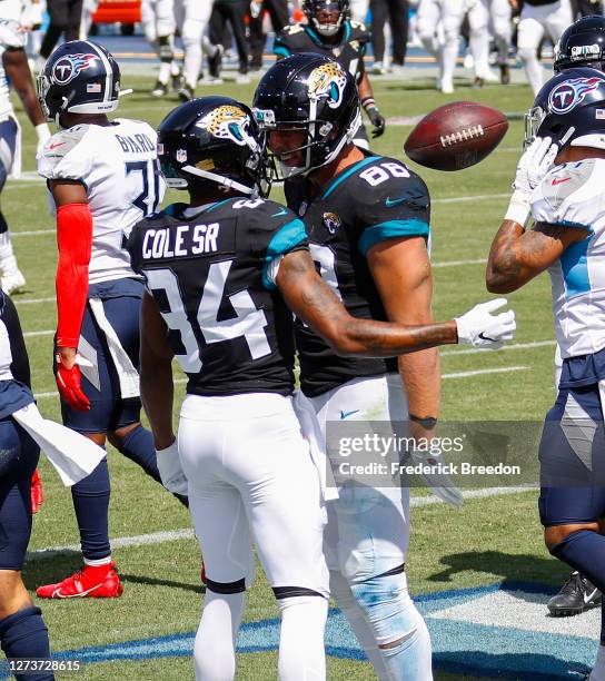 Tyler Eifert of the Jacksonville Jaguars is congratulated by teammate Chris Thompson after scoring touchdown against the Tennessee Titans during the...