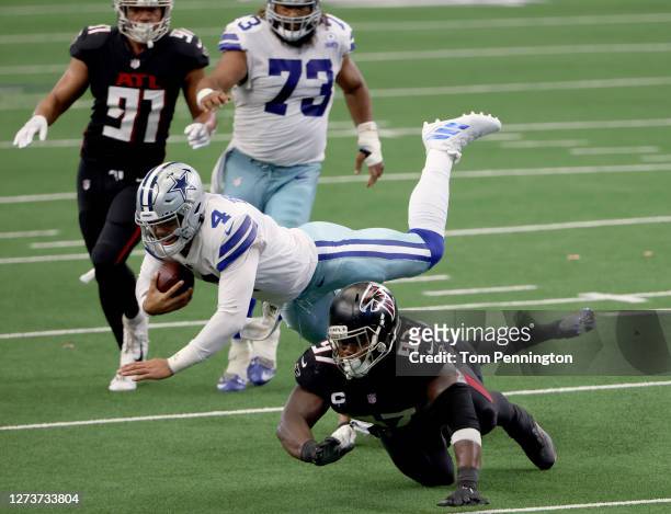 Dak Prescott of the Dallas Cowboys carries the ball against Grady Jarrett of the Atlanta Falcons and Darqueze Dennard of the Atlanta Falcons inn the...
