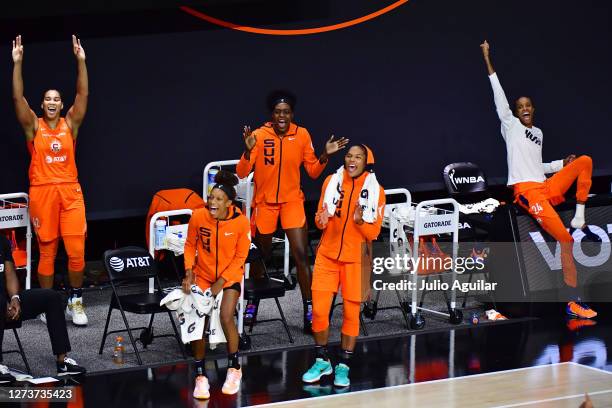 Brionna Jones, Jasmine Thomas, Beatrice Mompremier, Alyssa Thomas, and DeWanna Bonner of the Connecticut Sun react after Natisha Hiedeman scored on a...