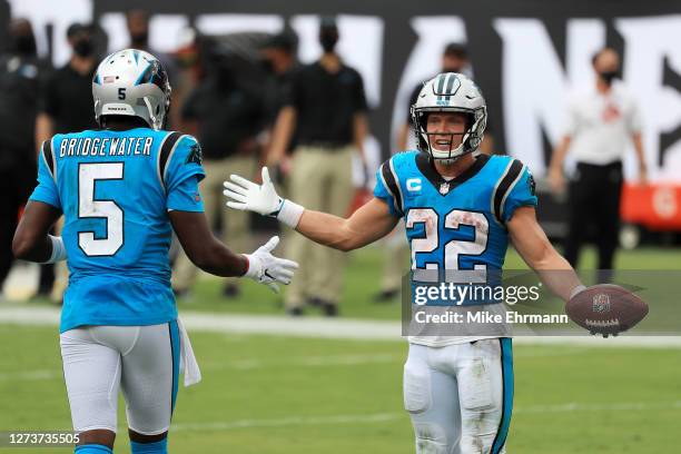 Christian McCaffrey of the Carolina Panthers celebrates with Teddy Bridgewater after scoring a touchdown during the third quarter against the Tampa...