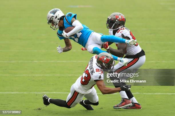 Robby Anderson of the Carolina Panthers is upended as he is tackled by Sean Murphy-Bunting and Jason Pierre-Paul of the Tampa Bay Buccaneers during...