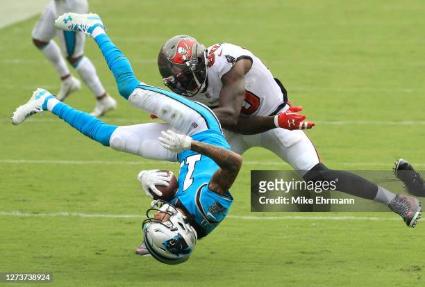 Robby Anderson of the Carolina Panthers is upended as he is tackled by Jason Pierre-Paul and Sean Murphy-Bunting of the Tampa Bay Buccaneers during...