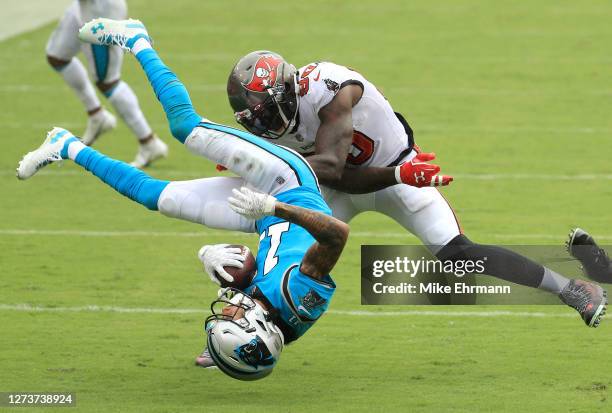 Robby Anderson of the Carolina Panthers is upended as he is tackled by Jason Pierre-Paul and Sean Murphy-Bunting of the Tampa Bay Buccaneers during...