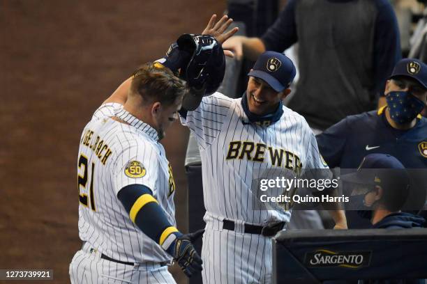 Daniel Vogelbach of the Milwaukee Brewers celebrates with hitting coach Andy Haines of the Milwaukee Brewers after his two run home run in the first...
