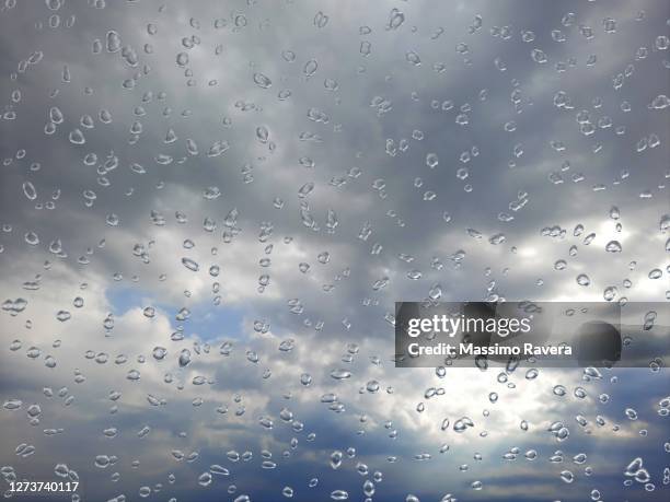 stormy sky behind a wet window. - storm outside window stock pictures, royalty-free photos & images