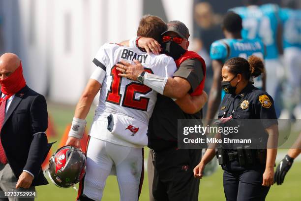 Tom Brady of the Tampa Bay Buccaneers hugs head coach Bruce Arians after defeating the Carolina Panthers 31-17 at Raymond James Stadium on September...