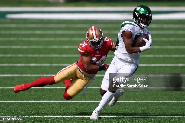 Chris Herndon of the New York Jets carries the ball as K'Waun Williams of the San Francisco 49ers defends during the first half of the game at...
