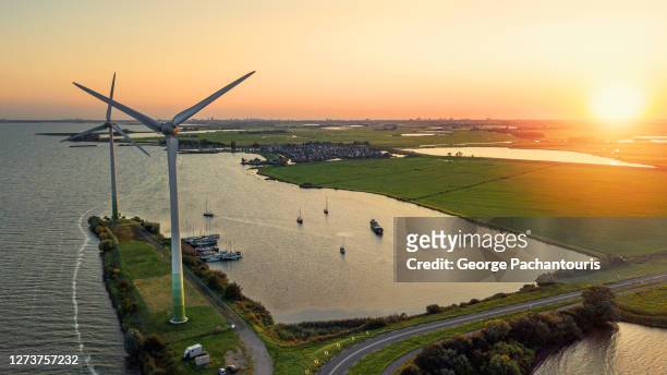 aerial view of wind turbines and sunset - olanda settentrionale foto e immagini stock