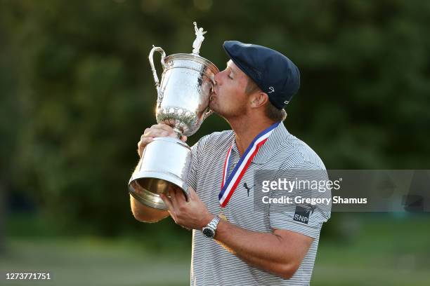 Bryson DeChambeau of the United States kisses the championship trophy in celebration after winning the 120th U.S. Open Championship on September 20,...