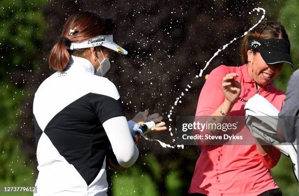 Hannah Green of Australia sprays champagne over Georgia Hall of England after she won the the Cambia Portland Classic on the second playoff hole at...