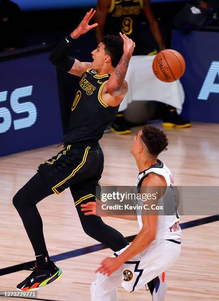 Kyle Kuzma of the Los Angeles Lakers looses the ball as he drives to the basket against Michael Porter Jr. #1 of the Denver Nuggets during the second...