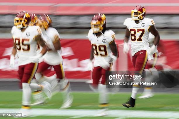 Tight end Jeremy Sprinkle of the Washington Football Team runs onto the field with teammates before the NFL game against the Arizona Cardinals at...