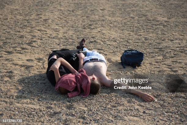 Couple relax on the beach in the late afternoon during the recent warm weather on September 20, 2020 in Southend on Sea, London.