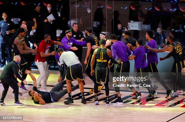 Anthony Davis of the Los Angeles Lakers celebrates with his temamates after shooting a three point basket to win the game over Denver Nuggets in Game...