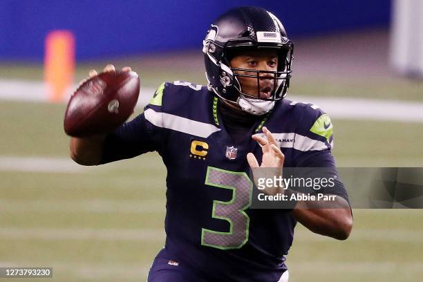 Russell Wilson of the Seattle Seahawks looks to pass during the second half against the New England Patriots at CenturyLink Field on September 20,...
