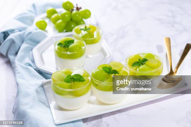 homemade yogurt mousse topped with grapes jelly - panna cotta stock pictures, royalty-free photos & images