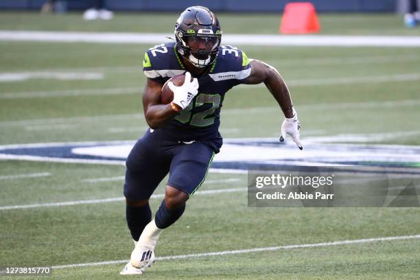 Chris Carson of the Seattle Seahawks runs with the ball in the first quarter against the New England Patriots at CenturyLink Field on September 20,...