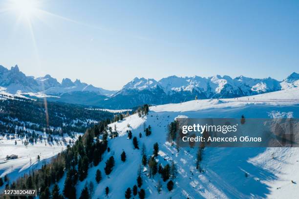 sunny winter landscape at ski area in dolomites, italy - alpe lusia. ski resort in val di fassa near moena - fassatal stock-fotos und bilder