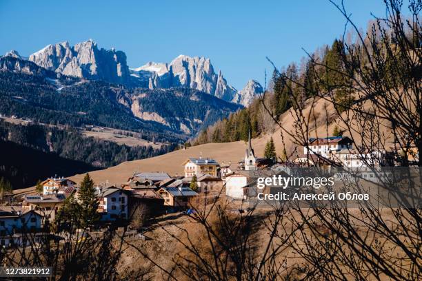 beautiful autumn alpine landscape with church and alpine houses. soraga. moena. bolzano province. south tyrol. italy - soraga stock pictures, royalty-free photos & images