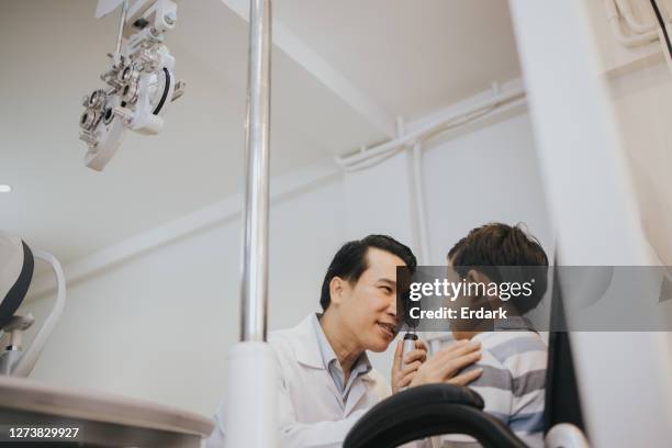 doctor using occluder for checking customer's eye at clinic-stock photo - body conscious stock pictures, royalty-free photos & images
