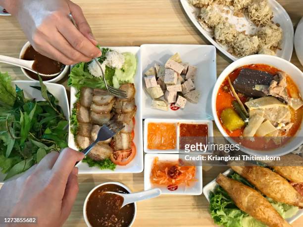 friends enjoy vietnamese food together. - vietnamese food stock pictures, royalty-free photos & images