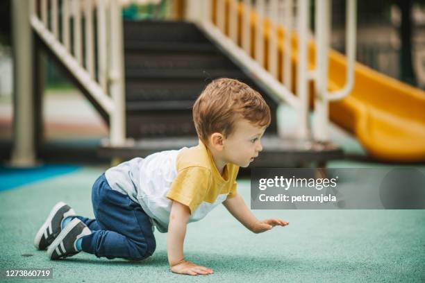 baby boy exploring park. - crawling stock pictures, royalty-free photos & images