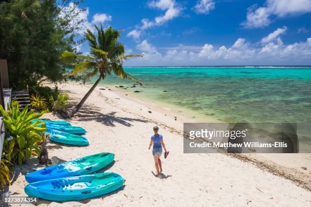 woman on the beach in muri, rarotonga, cook islands, background with copy space - rarotonga stock pictures, royalty-free photos & images
