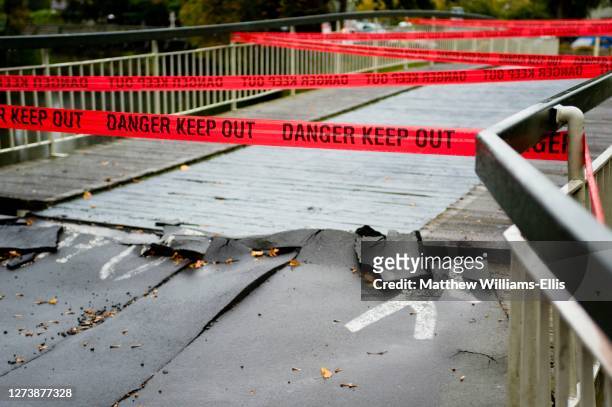 red tape reading danger keep out preventing people crossing a bridge. taken in christchurch after the earthquake which struck on 22nd february 2011. - christchurch earthquakes stock pictures, royalty-free photos & images