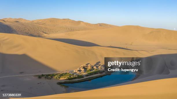 crescent lake with buddhist temple in kumtag desert, dunhuang, gansu china - stock photo - beautiful oasis stock pictures, royalty-free photos & images
