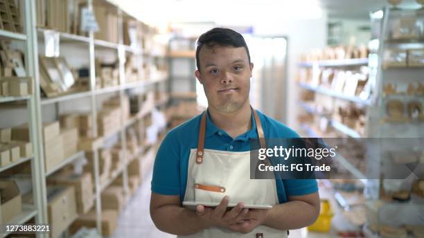 portrait of a special needs salesman working in a store - craft market stock pictures, royalty-free photos & images