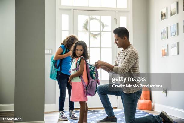 father packing daughters backpacks for school - are you ready stock pictures, royalty-free photos & images