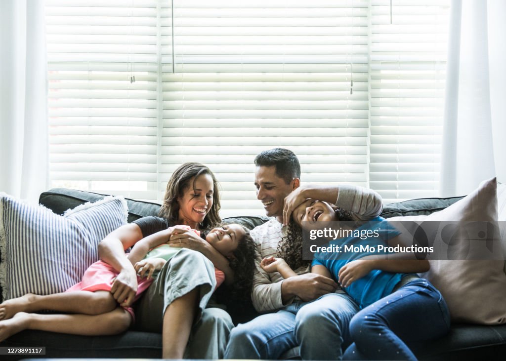 Portrait of young family of sofa at home