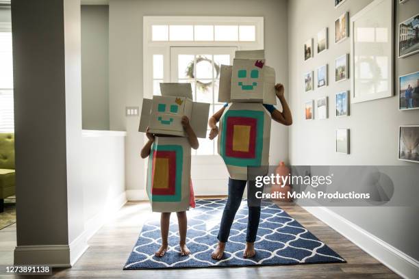 young girls wearing homemade robot costumes at home - funny black girl stock-fotos und bilder